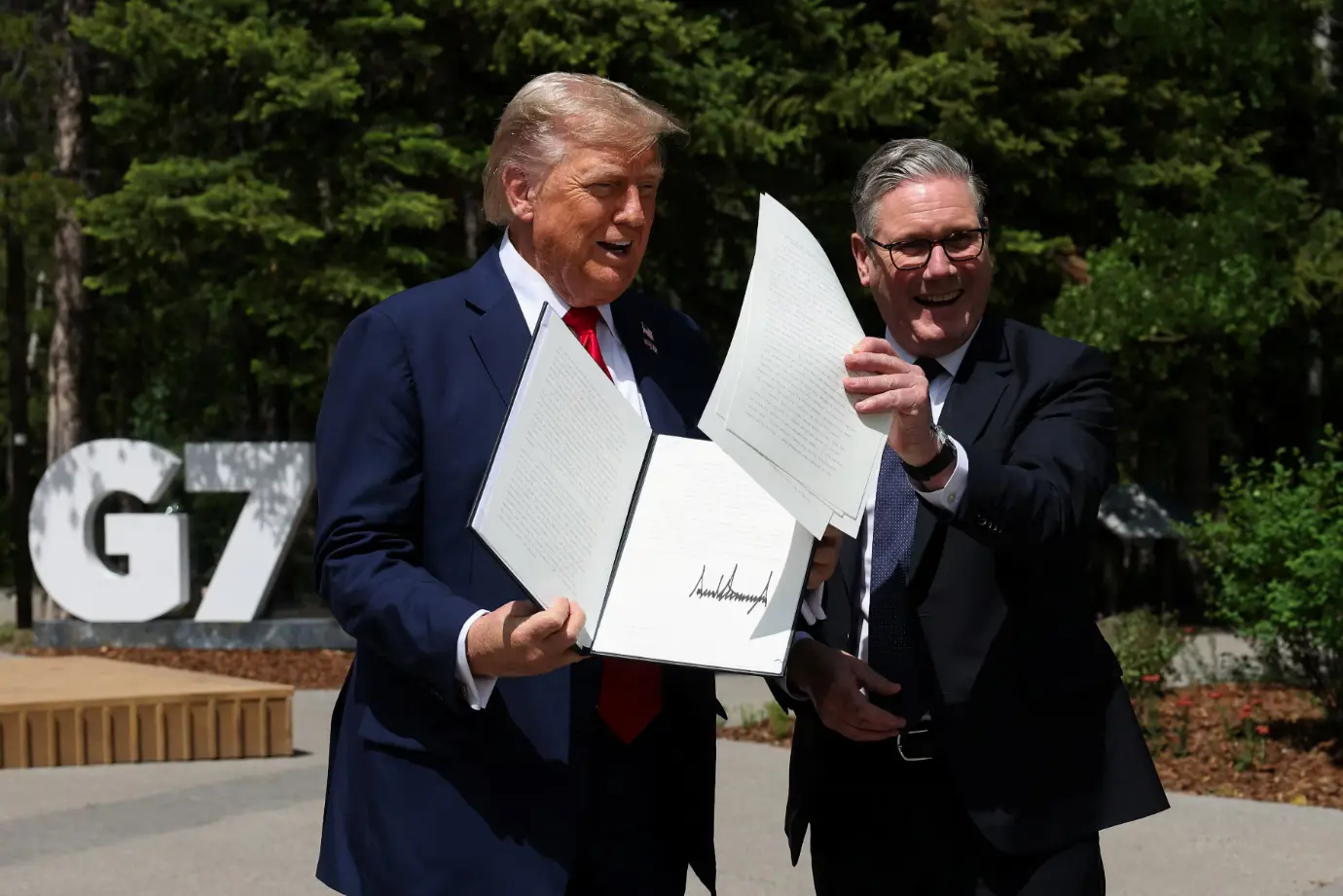 Trump signs US–UK trade deal at G7, says Britain ‘protected because I like them’
