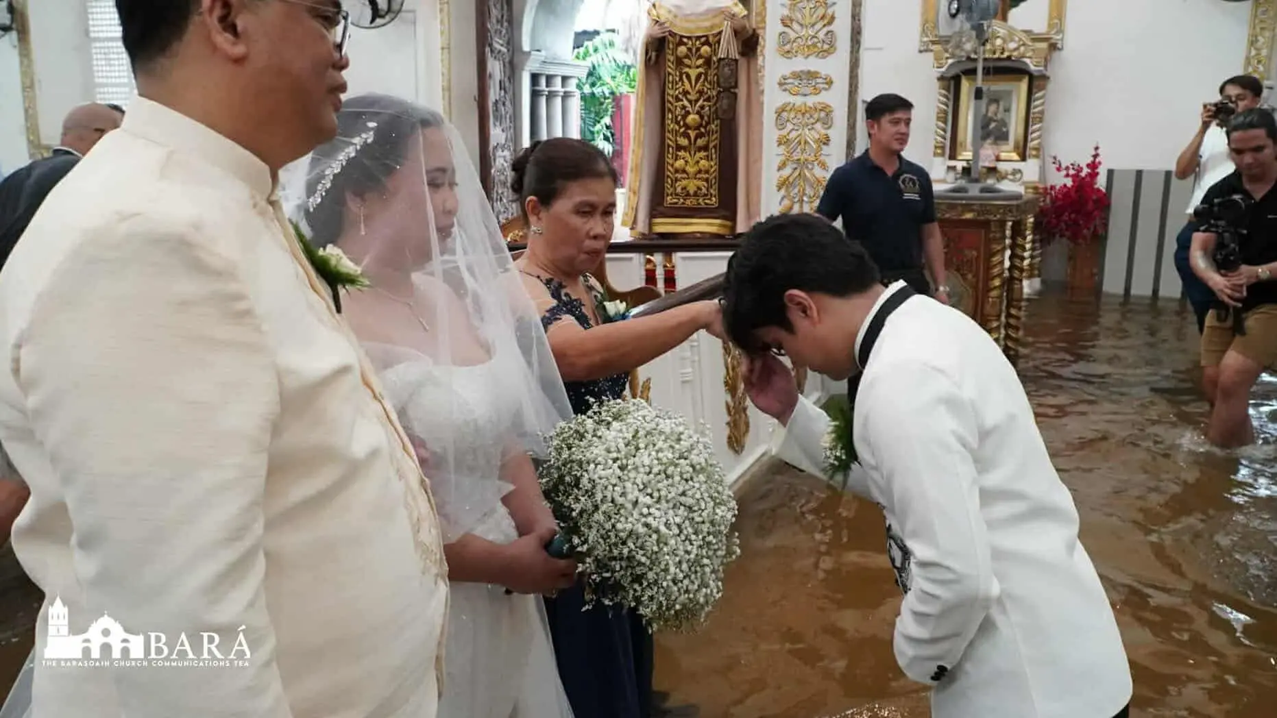 Rain or shine: Filipino couple says ‘I Do’ in flooded church after Typhoon Wipha