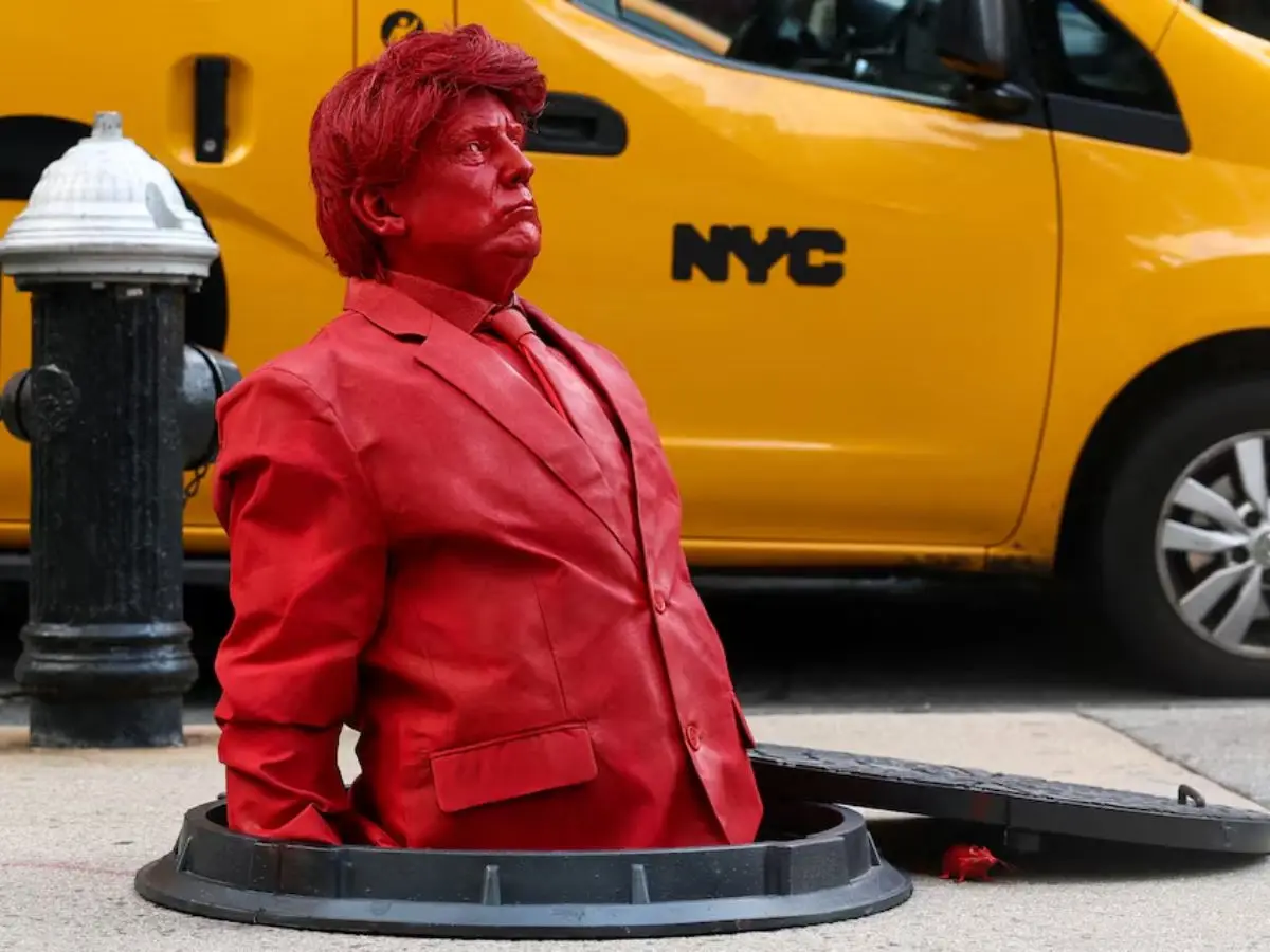 Bright red Trump sculpture appears from a manhole in Manhattan - White House reacts Bright red Trump sculpture appears from a manhole in Manhattan - White House reacts