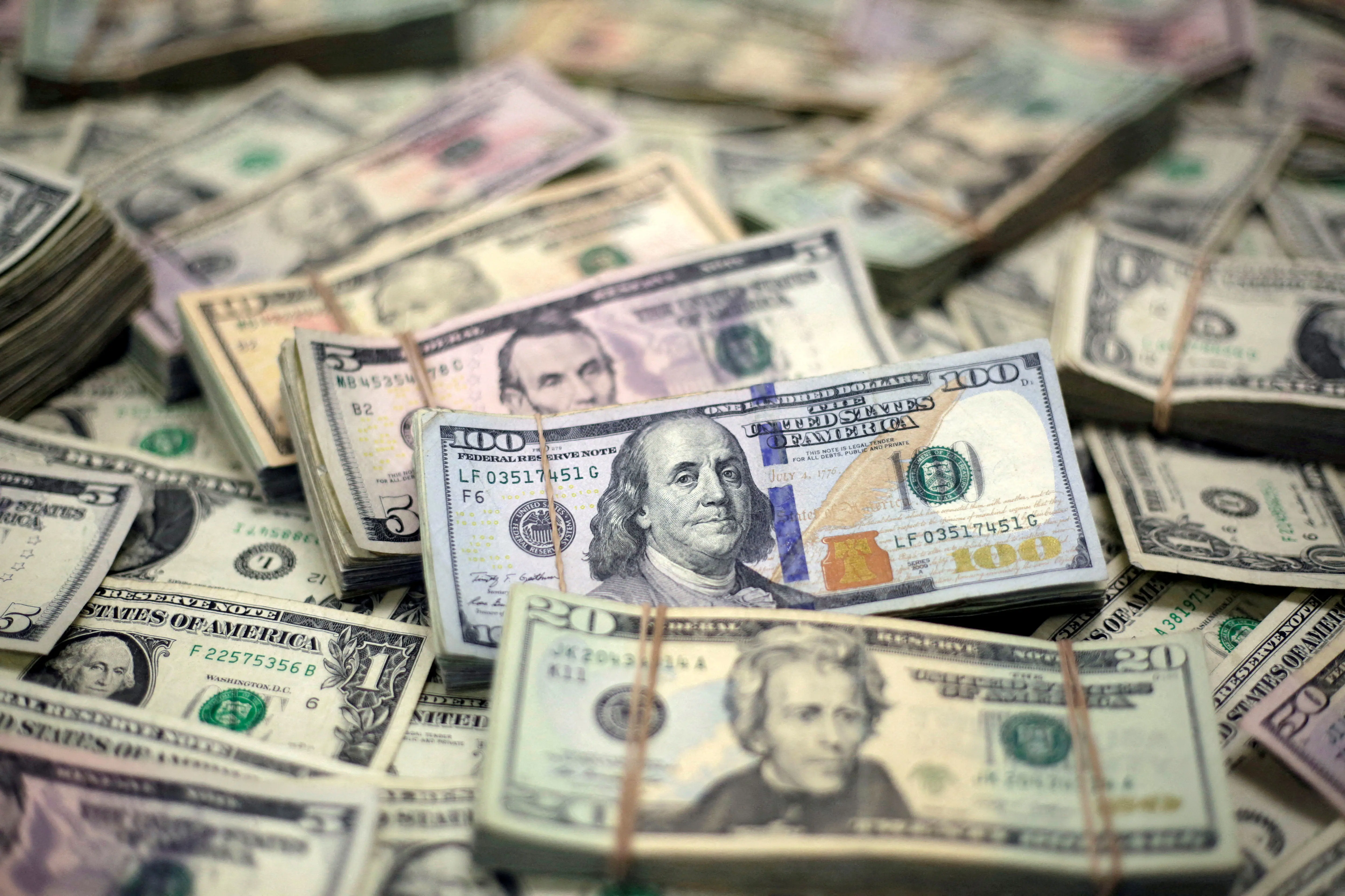 Dollar holds gains on Fed cut bets; RBA decision keeps Aussie in check