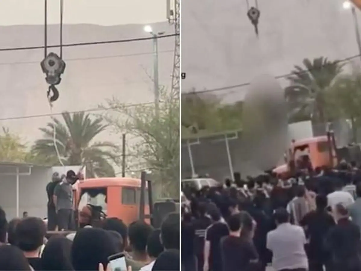 Iranian man convicted of murder hanged publicly from a crane at crime scene