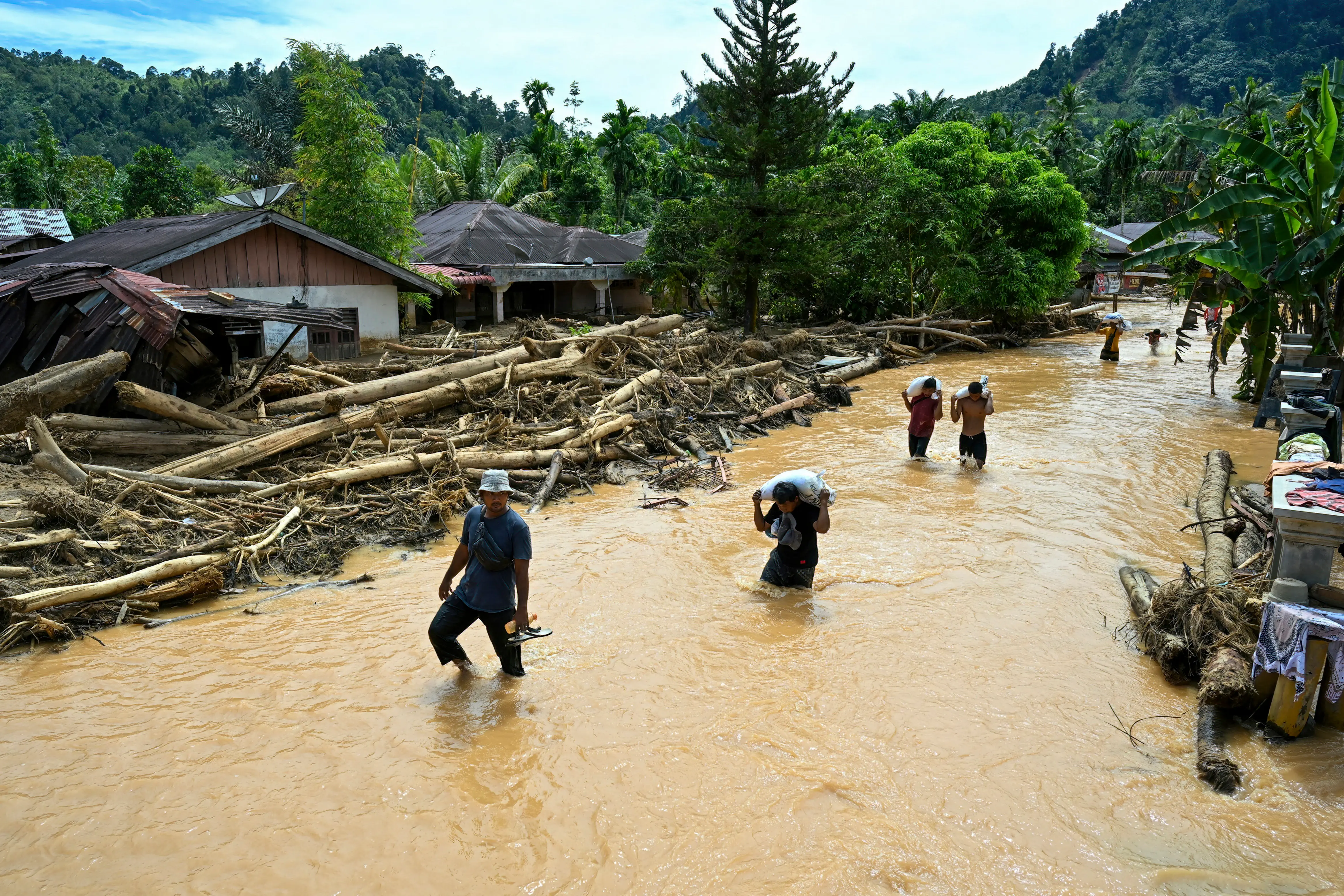 Frustration mounts in Indonesia and Sri Lanka amid aid workers face challenges in reaching flood survivors