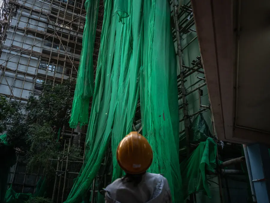 Hong Kong races to remove scaffolding nets blamed for fire that claimed 159 lives