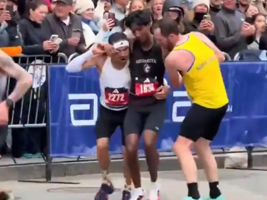 WATCH: Collapsed near finish line, two participants carry runner to complete Boston Marathon