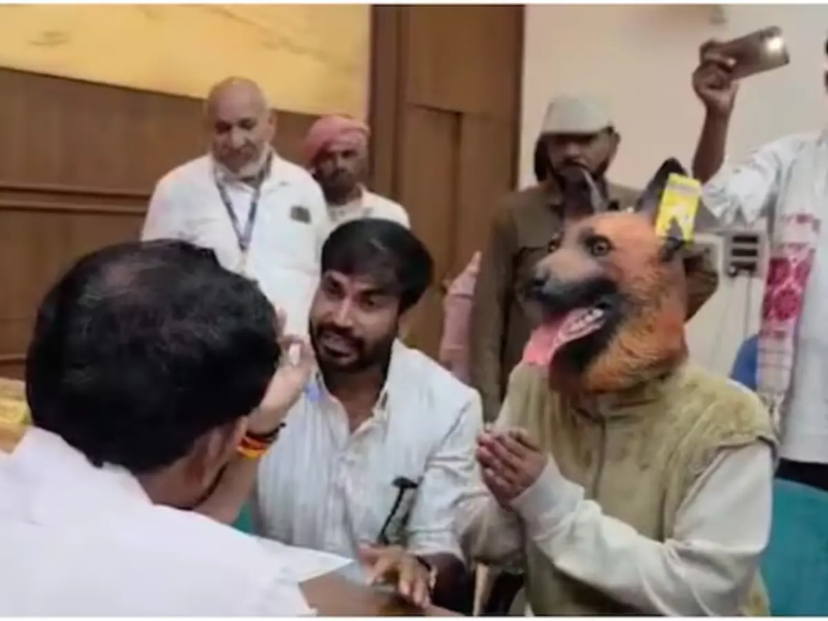 Indian politician brings man wearing dog mask to police station to protest dog menace Indian politician brings man wearing dog mask to police station to protest dog menace